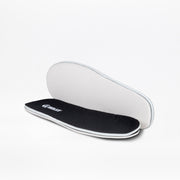 A pair of Black to the Floor BILLY Sport Inclusion insoles by BILLY Footwear are shown, with one displaying the black cushioned top and the other revealing the white underside, designed for athletic zipper shoes or kids sneakers.