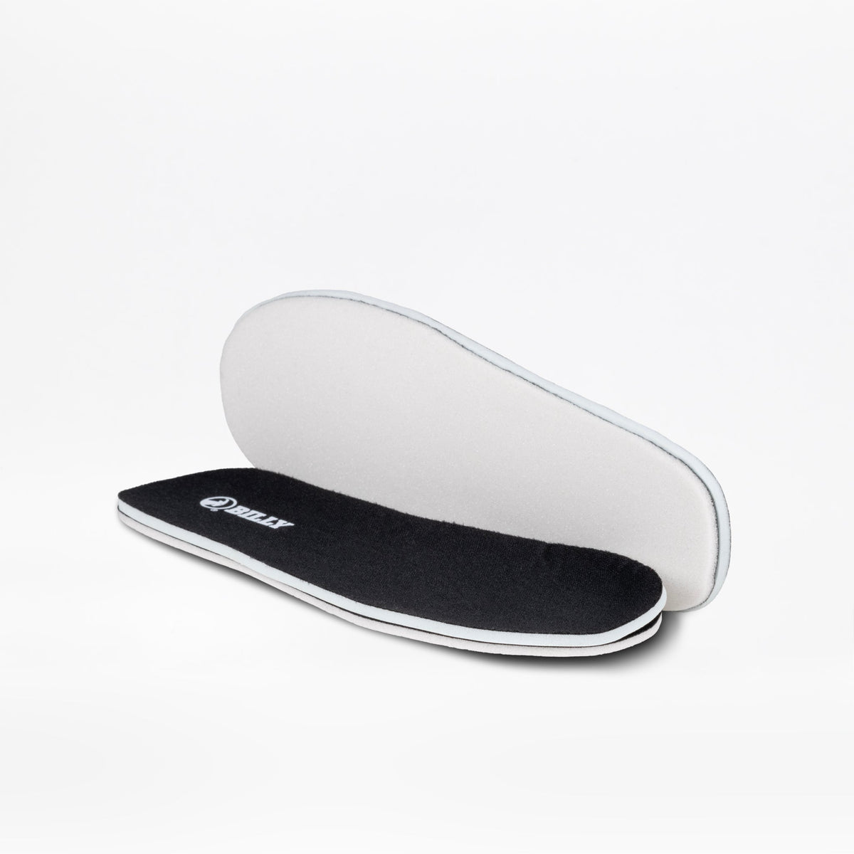 A pair of Black to the Floor BILLY Sport Inclusion insoles by BILLY Footwear are shown, with one displaying the black cushioned top and the other revealing the white underside, designed for athletic zipper shoes or kids sneakers.
