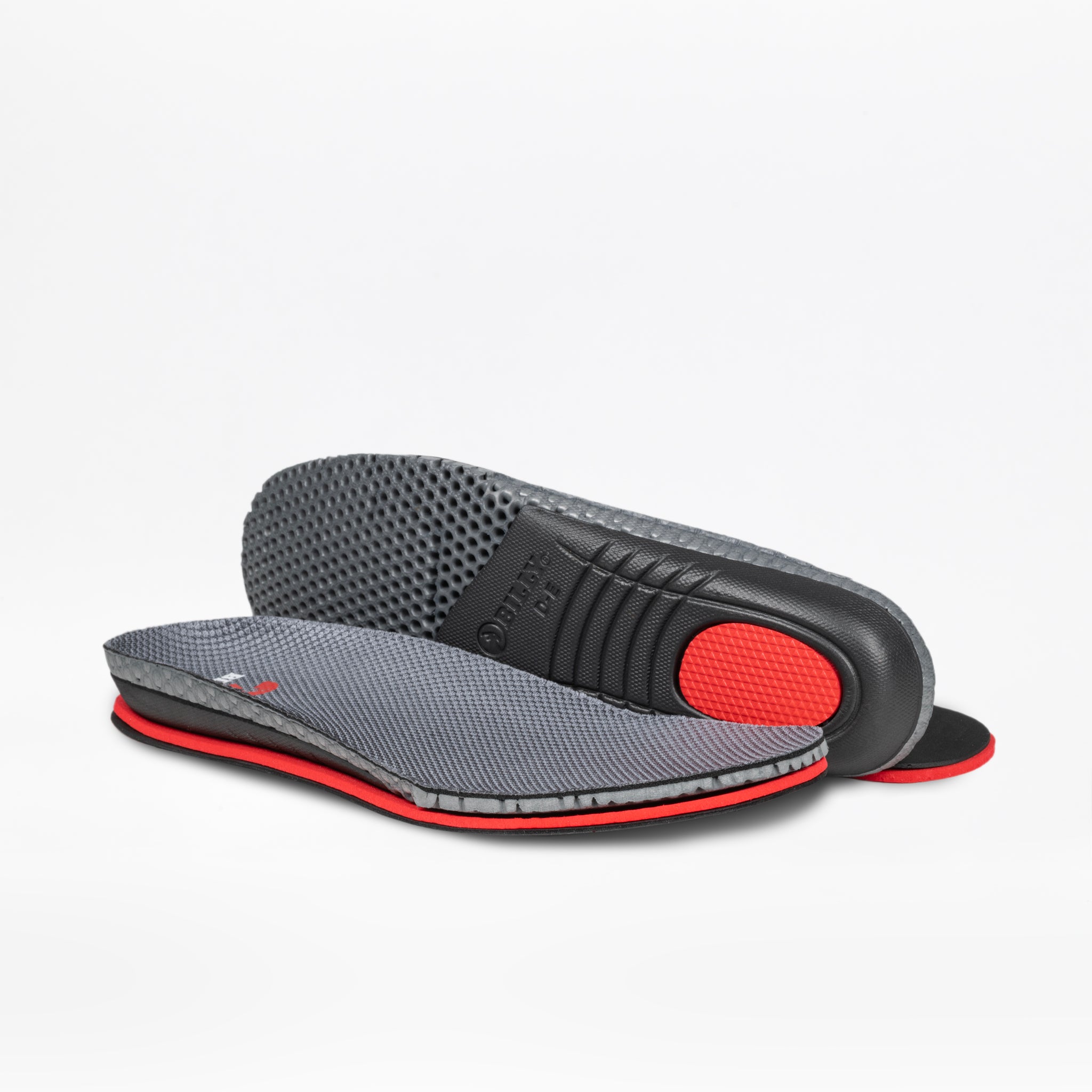 The Men's Charcoal BILLY Limitless insoles by BILLY Footwear are displayed, with one flat and the other upright to reveal the textured black underside and cushioned red heel area.